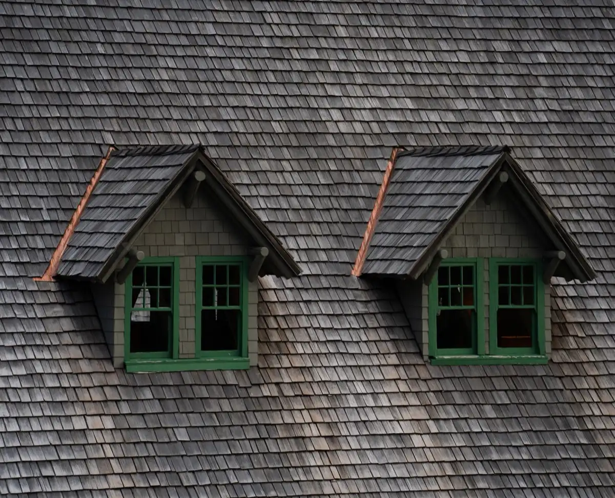Dormers on a shingle roof in Warner Robins, GA, where step flashing and kickout flashing carry water past the walls